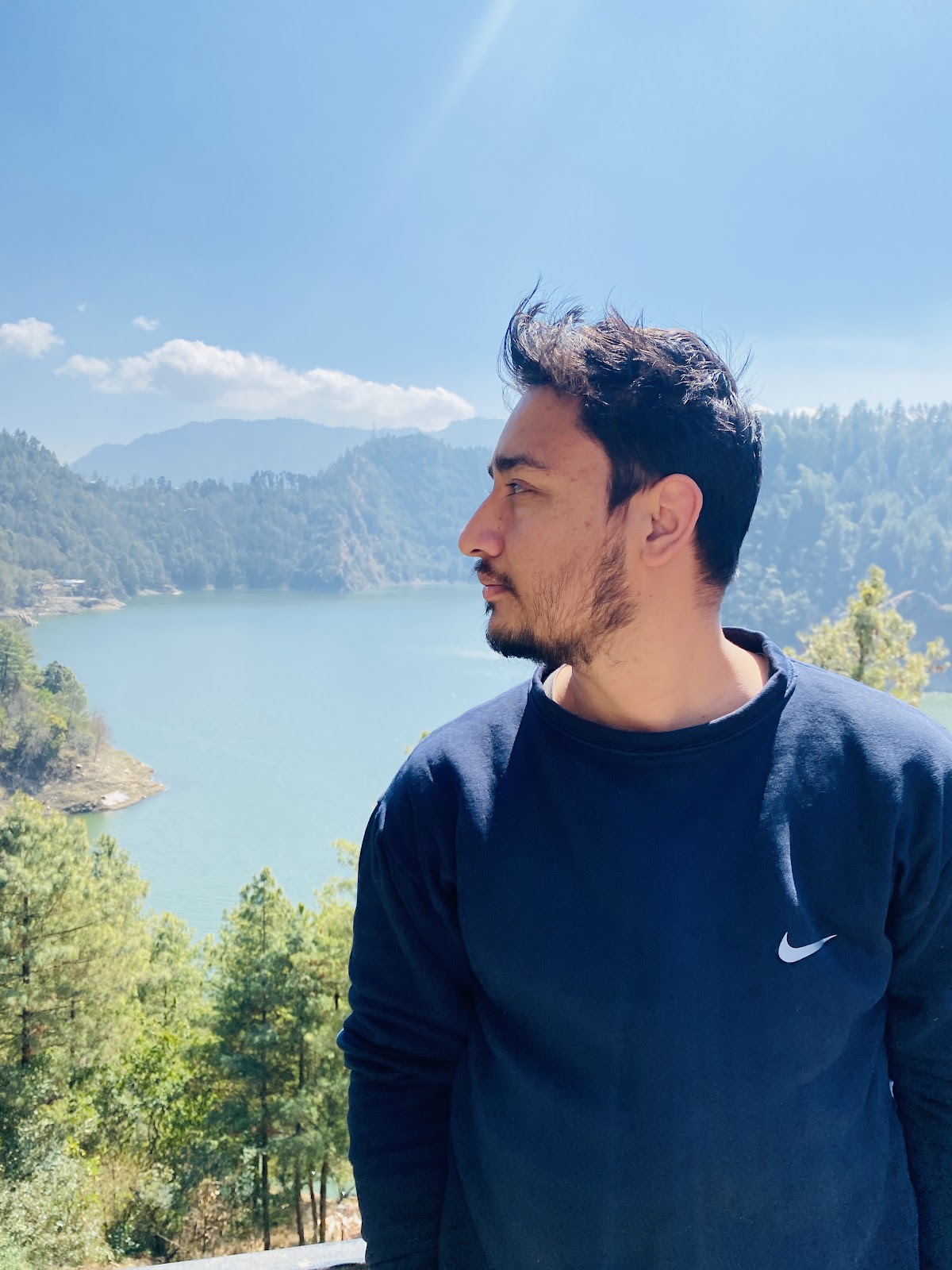 Rahul Poudel looking out over a Himalayan lake